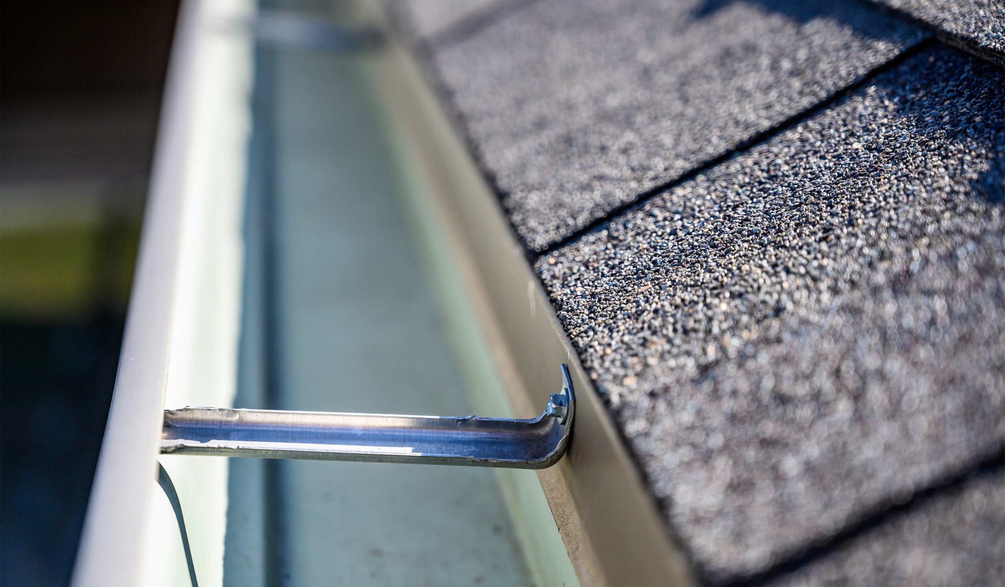 asphalt shingles roof close up with cleaned gutter canton ms